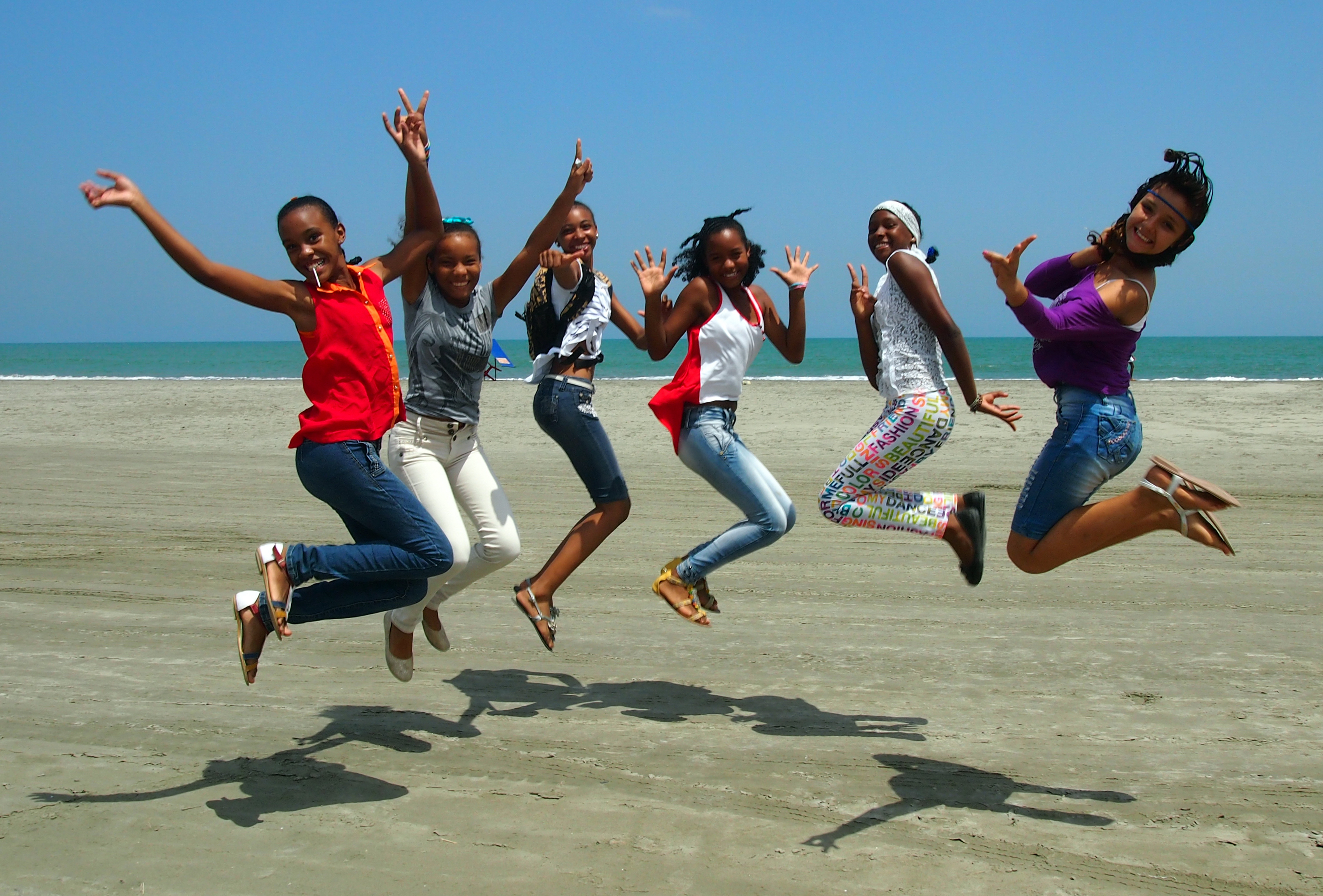 9thgrade female students jumping in air together, La Boquilla, Colombia, 2014, PC Digital Library