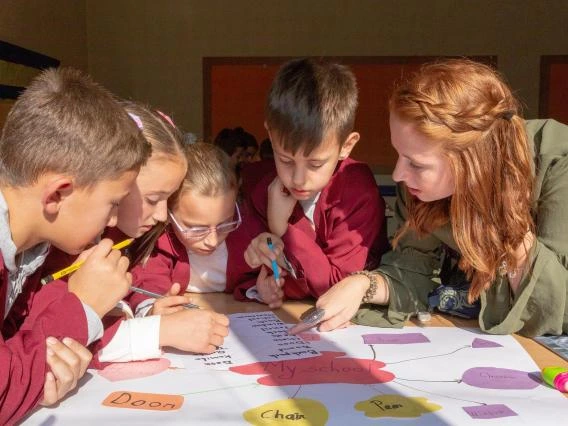 UA student instructing children
